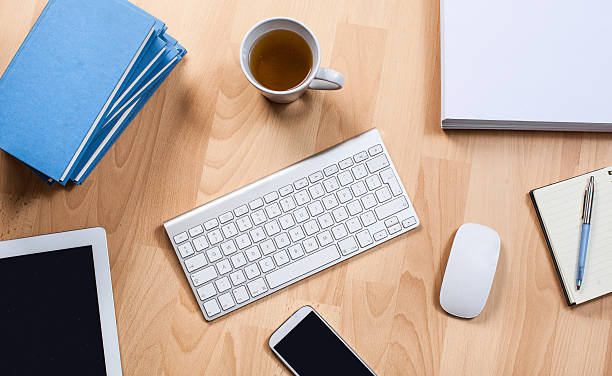istock office desk with keyboard, books , tablet , pc and mobile 466410878