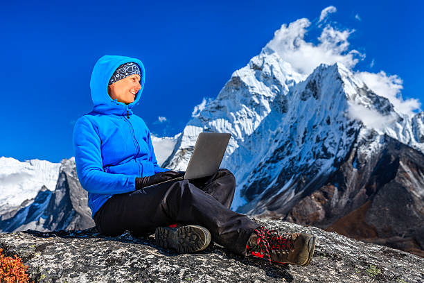 istock Woman is using laptop in Mount Everest National Park, Nepal 466412443