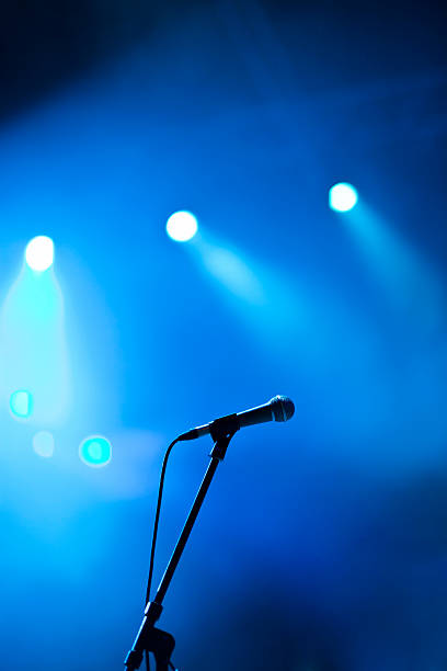 Microphone on concert Microphone on concert stage. Shallow DOF, selective focus. microphone stand stock pictures, royalty-free photos & images