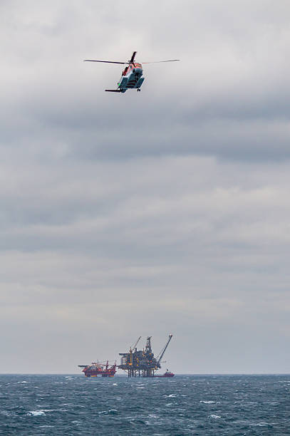 istock oil rig platform at sea and helicopter in flight 466412615