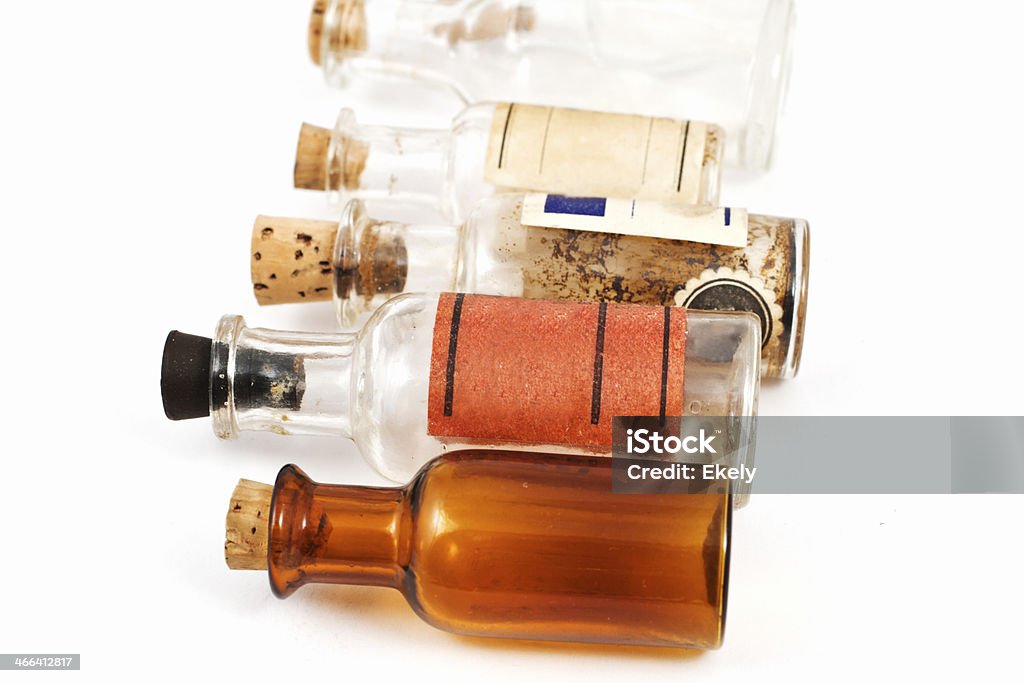 Group of small vintage translucent medicine bottles. Old medicine bottles with labels on white background. Antique Stock Photo