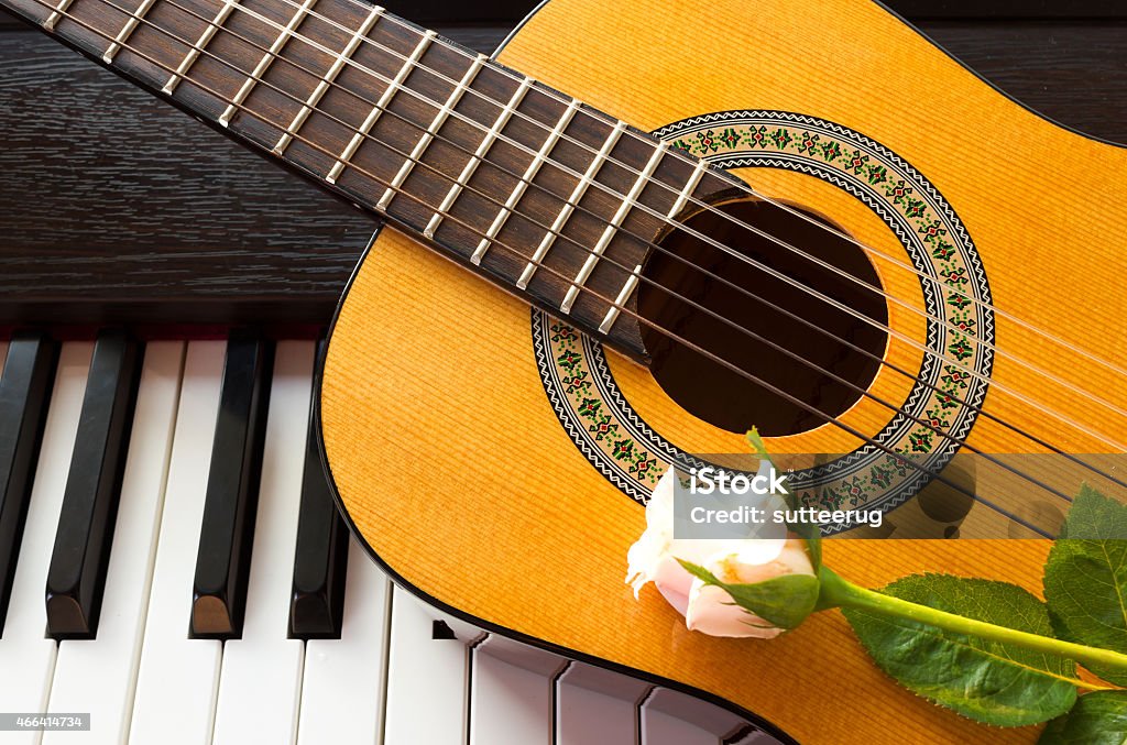 Rose on guitar with piano key. Closeup pink rose on guitar with piano key. 2015 Stock Photo