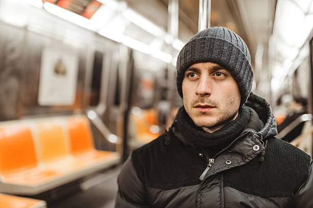 istock caucasian pensive man with knit hat on the metro 466415203