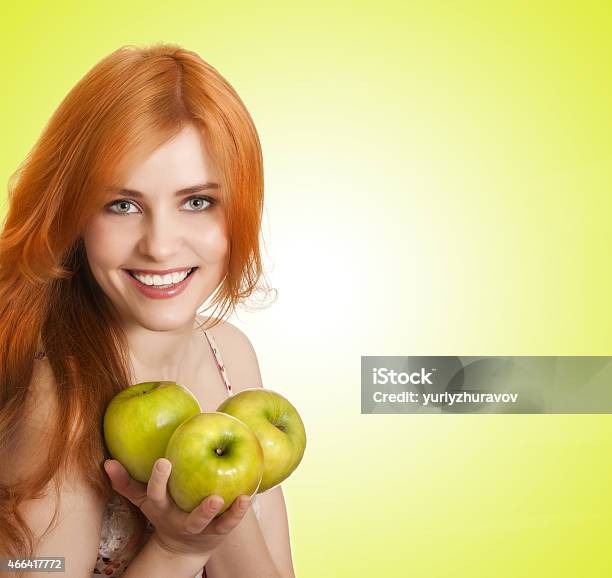 Young Beauty Woman With Apple On Green Background Stock Photo - Download Image Now - 2015, Adult, Adults Only