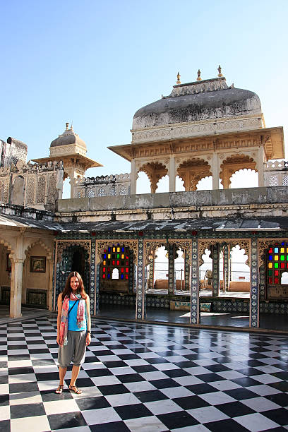 istock Young woman standing at Peacock Square, City Palace complex, Uda 466420265