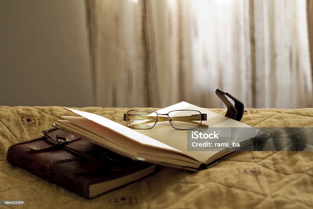 Two books with glasses Two books. One is open with glasses. Vintage style . Beige Stock Photo