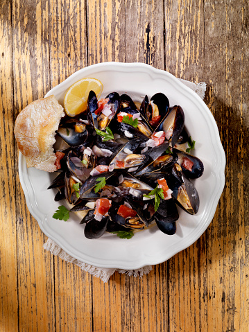 Mussels in Cream Sauce with Tomatoes and Garlic, Fresh Parsley and Bread -Photographed on Hasselblad H3D2-39mb Camera