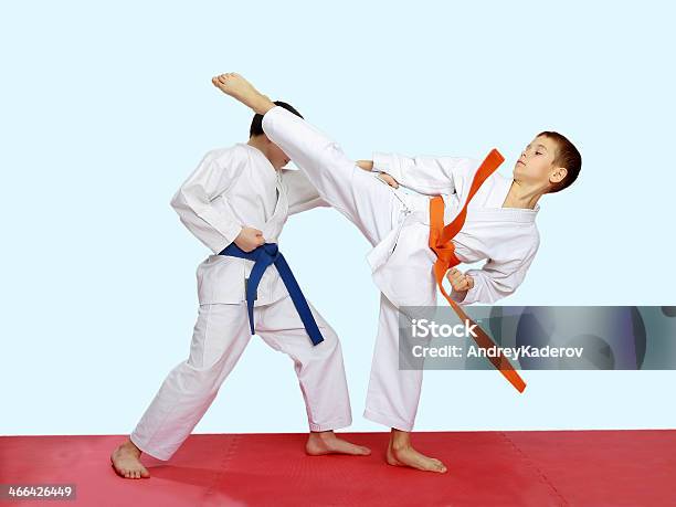 Blows Karate Are Training Athletes On A Bright Background Stock Photo - Download Image Now