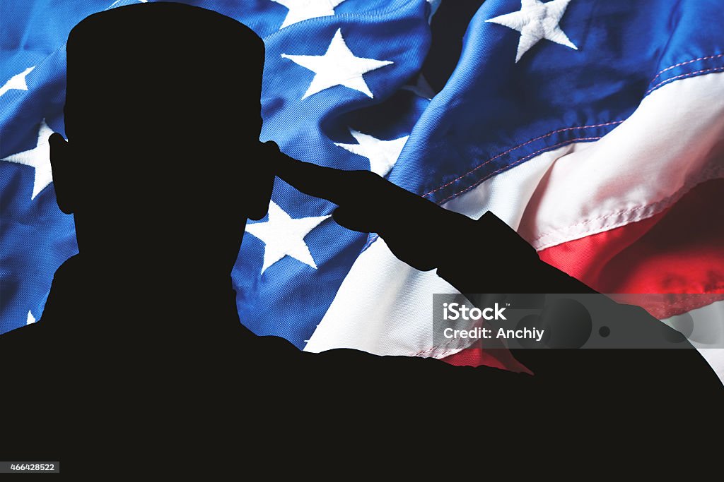 Proud saluting male army soldier on american flag background Proud saluting male army soldier on american flag background (Memorial day, Veteran's day, 4th of july, Independence day) Saluting Stock Photo