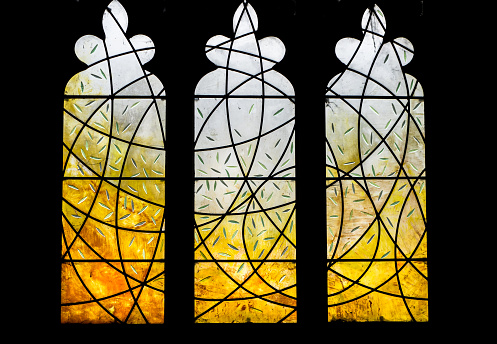 A modern stained glass design n a traditional church window.