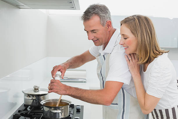istock Side view of a couple preparing food in kitchen 466429348
