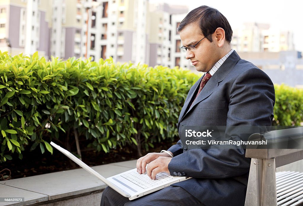 One Young Confident Indian Corporate Businessman Using Laptop Outdoors View more from this photo shoot... 25-29 Years Stock Photo