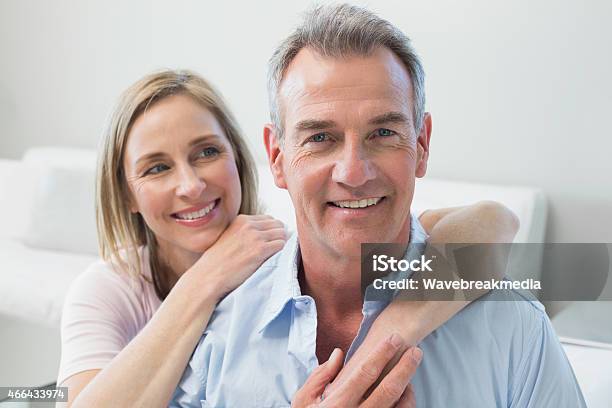 Low Saturation Portrait Of Smiling Middle Aged Couple Stock Photo - Download Image Now