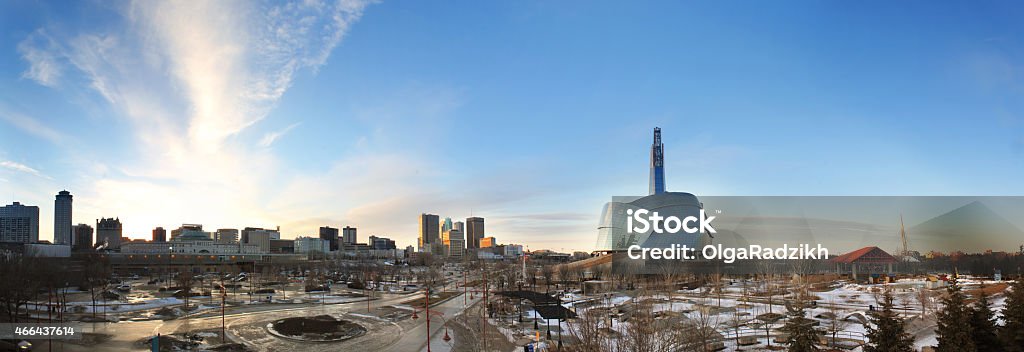 A skyline view of Winnipeg during the day A long panorama of Winnipeg. The Canadian Museum for Human Rights, as well as tall buildings downtown can be seen in the skyline. Shot from The Forks. Very wide angle. Winnipeg Stock Photo
