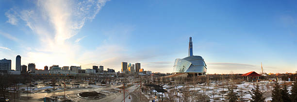 A skyline view of Winnipeg during the day A long panorama of Winnipeg. The Canadian Museum for Human Rights, as well as tall buildings downtown can be seen in the skyline. Shot from The Forks. Very wide angle. manitoba photos stock pictures, royalty-free photos & images