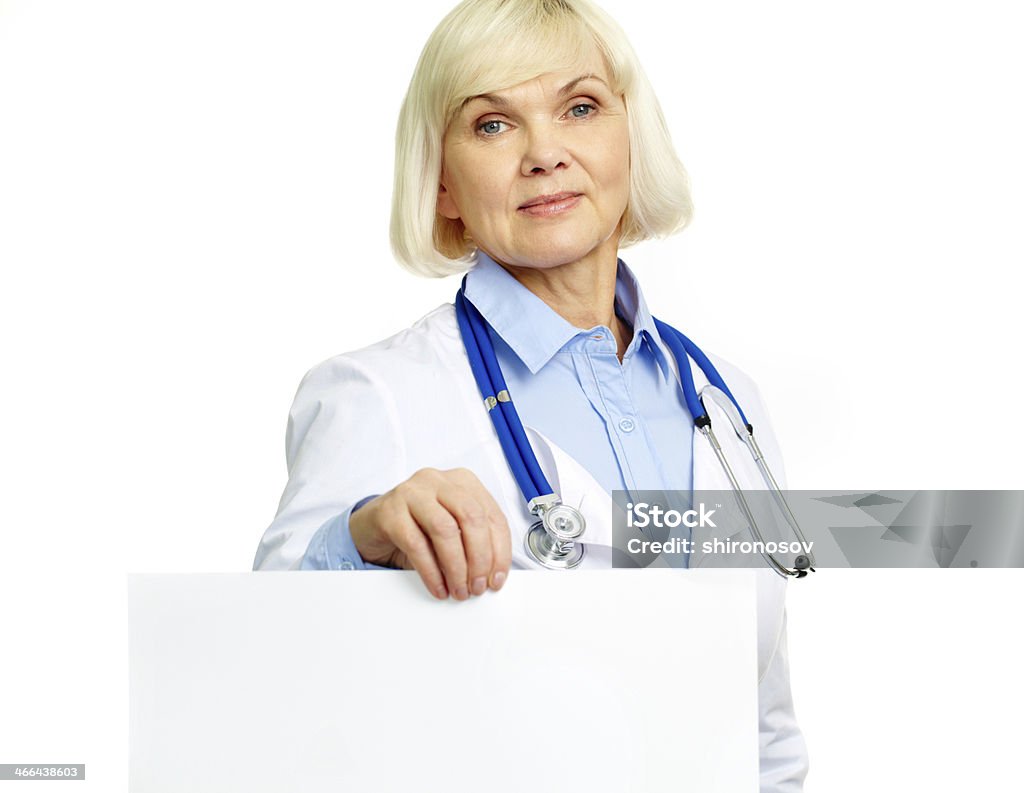 Medical ad Medical worker holding a blank sheet of paper in front of the camera Active Seniors Stock Photo