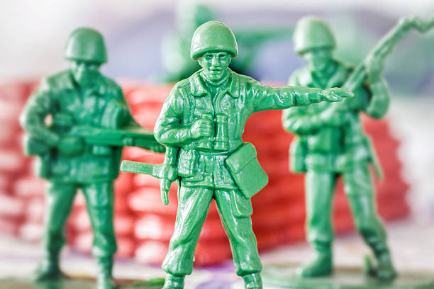istock Leadership concept with little green armed soldier toy 466441426