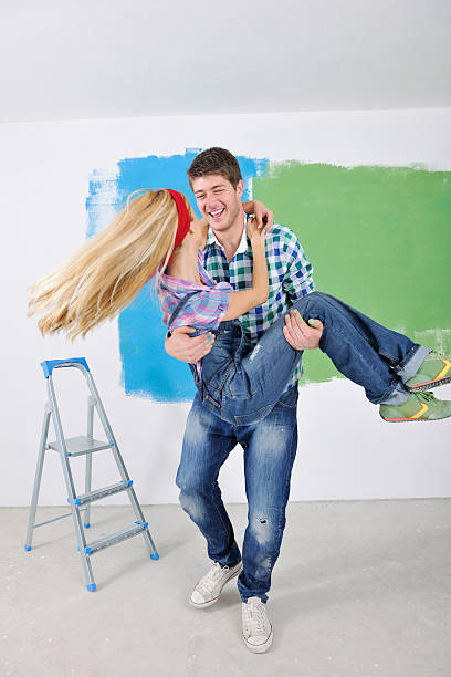 istock happy couple paint wall at new home 466441773