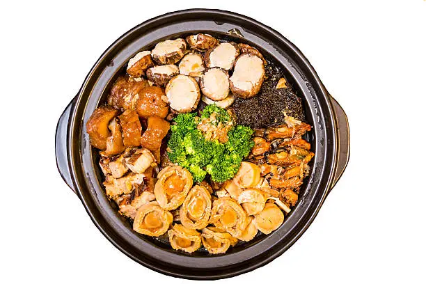 Chinese styled Abalone mixed dish. Also known as "Poon Choy" in Chinese.  Ingredients includes abalone, scallop, oyster, shitake mushroom, pork meat, brocolli, fish maw, among others.  Isolated in white.