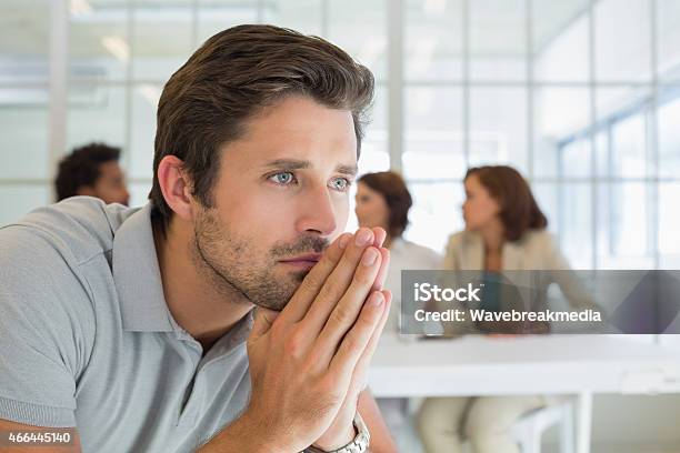 Serious Businessman With Colleagues In Meeting Stock Photo - Download Image Now - 20-24 Years, 20-29 Years, 2015