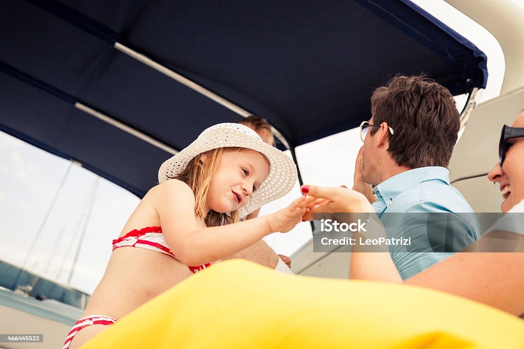 Happy young family and sons playing together Happy young family and sons playing on board of a luxury yacht. 2-3 Years Stock Photo