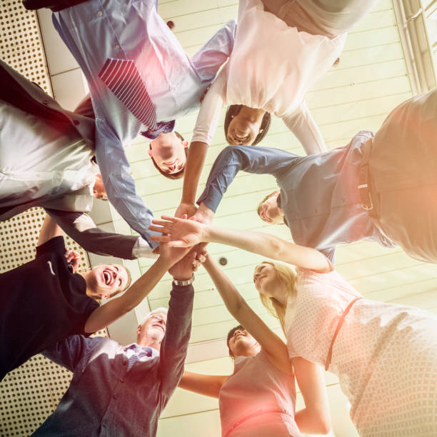 istock Unity of successful multi-ethnic business people holding hands 466452956