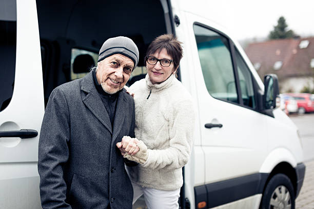 istock nurse helping senior man enter a van 466456967