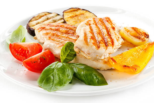 istock Barbecued chicken fillets and vegetables on white background 466457036