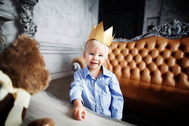 business prince cute baby smiling cheerful happy with crown success stock photo
