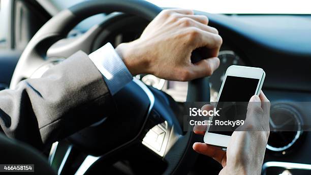 Businessman Texting While Driving A Car Stock Photo - Download Image Now - Chauffeur, Forbidden, Danger