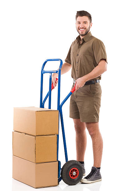 istock Smiling courier posing with a delivery cart 466458382