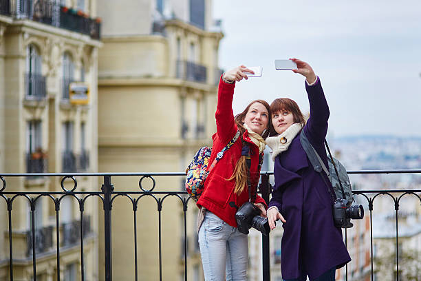 istock Two cheerful girls taking selfies in Paris 466458658