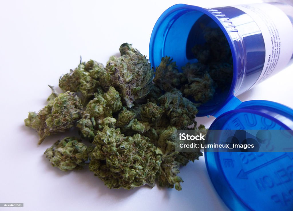Medical Marijuana Medical marijuana prescription bottle container with cannabis buds falling out. (Charlotte's Web strain) Cannabis Plant Stock Photo