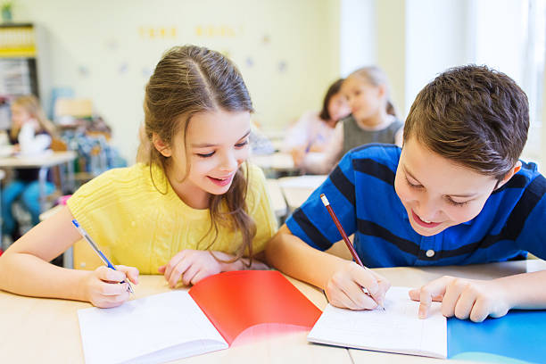 istock group of school kids writing test in classroom 466469046