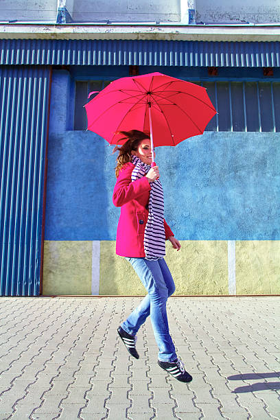 istock Woman with red umbrella 466469222