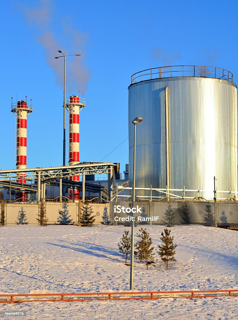 Boiler tube urban winter against the blue sky Smoking chimneys city boiler house in the winter against the blue sky 2015 Stock Photo