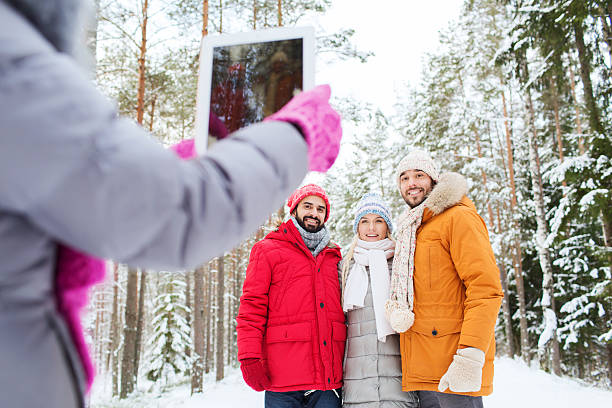 istock Friends taking a picture with digital tablet on a snowy day 466469576