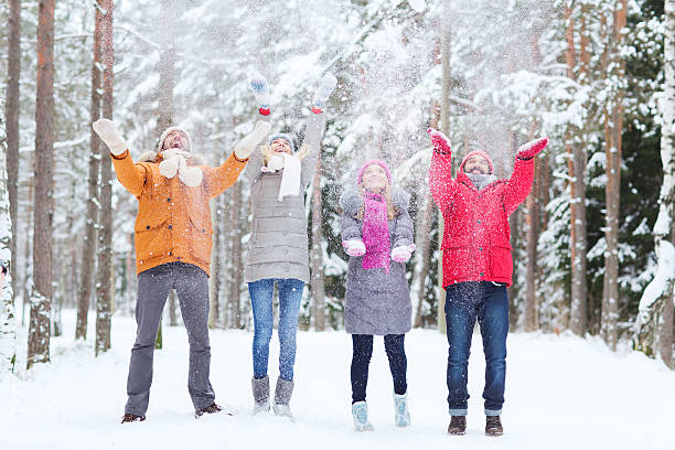 istock group of happy friends playin with snow in forest 466469578