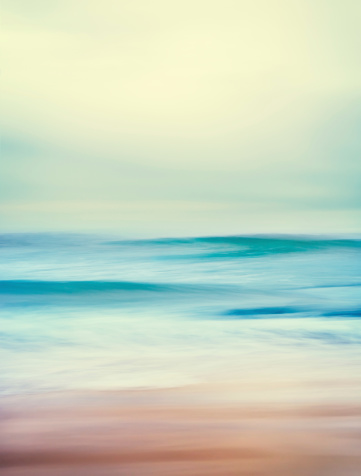 An abstract seascape with blurred panning motion and long exposure.  Image displays a retro, vintage look with cross-processed colors.
