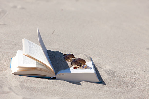 istock Sunglasses lies on an opened book 466470573