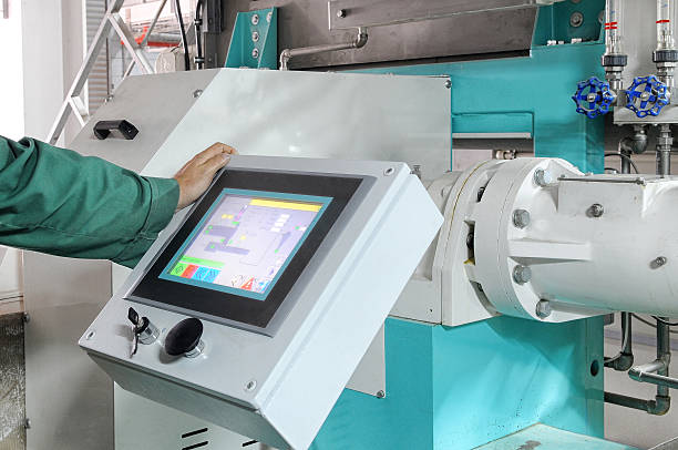 istock Man's arm on a large factory machine with a computer screen 466475958
