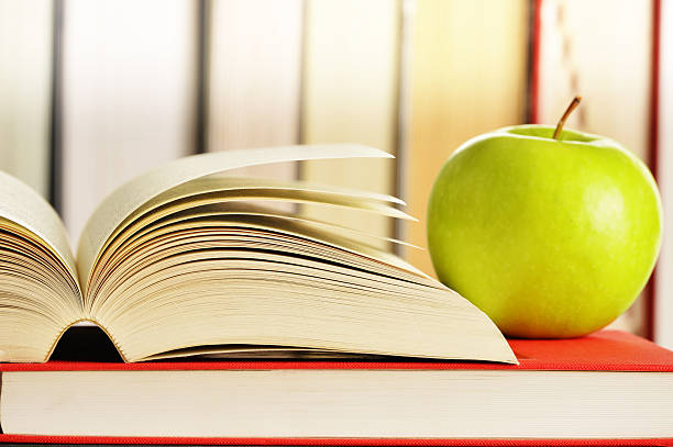 istock Composition with green apple and books on the table 466476159