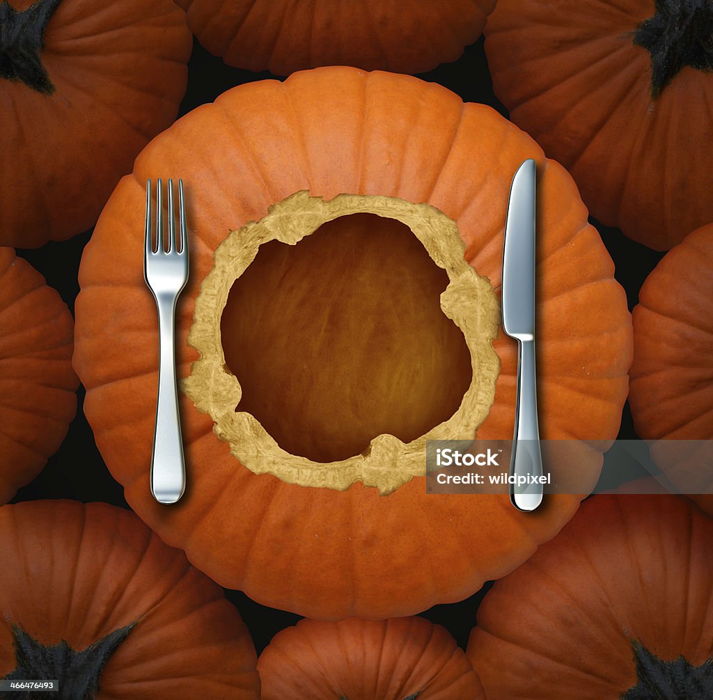 Thanksgiving Food Thanksgiving seasonal food celebration concept as an autumn cuisine symbol with an orange pumpkin cut as a circular dinner plate with a fork and knife table setting for gourmet fall food menu with a blank area as copy space. Agriculture Stock Photo