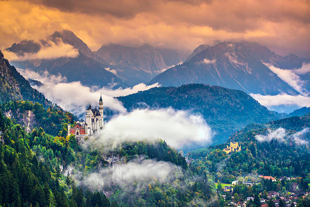 Wide-view of magnificent Neuschwanstein Castle in mountains Neschwanstein Castle in the Bavarian Alps of Germany. neuschwanstein castle stock pictures, royalty-free photos & images