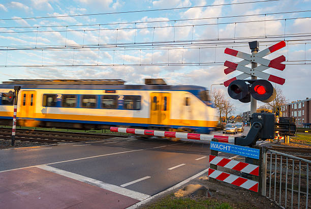 istock Train passing a rail crossing in a city 466478578