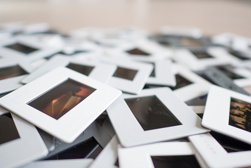 A pile of 35mm colour film slides, close-up. My own images.