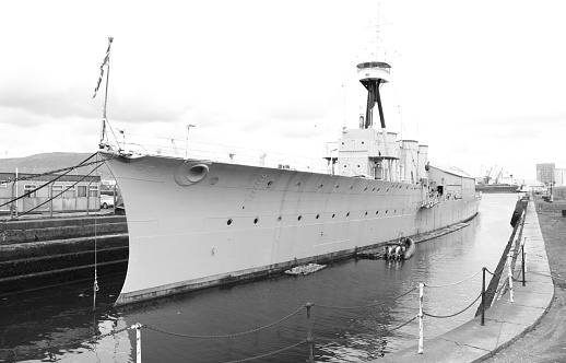 A black and white image of a world famous War War 1 British battleship for the Royal Navy.   Docked and resting in Belfast, Northern Ireland.