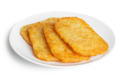 Potato Patties or Hash Browns, front to back focus, isolated on white, clipping path around plate.