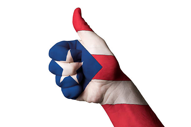 Hand with thumb up gesture in colored puerto rico national flag as symbol of excellence, achievement, good, - for tourism and touristic advertising, positive political, cultural, social management of country