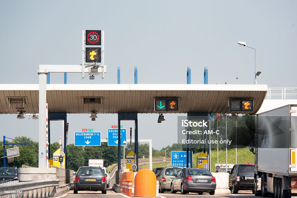 Toll gate at Macon in France Macon, France - July 11, 2013: Highway toll gate at Macon in France. At the toll booth  people take a ticket from an automatic machine when they enter the autoroute, and pay according to the distance when exiting. Toll Booth Stock Photo